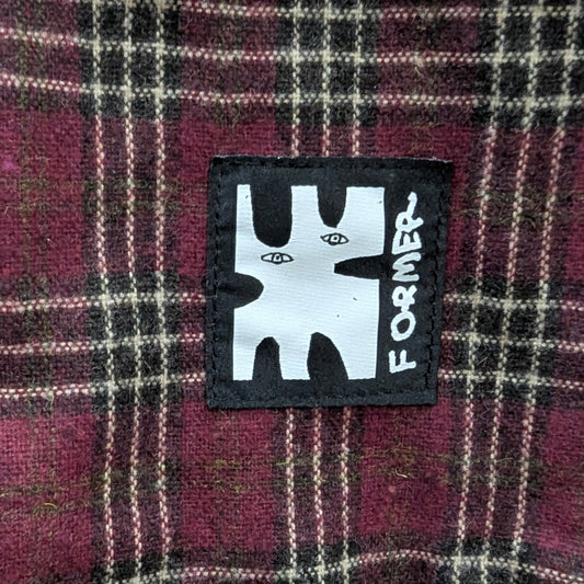 Plaid fabric with a 'Former' brand patch in the center welcome boardstore