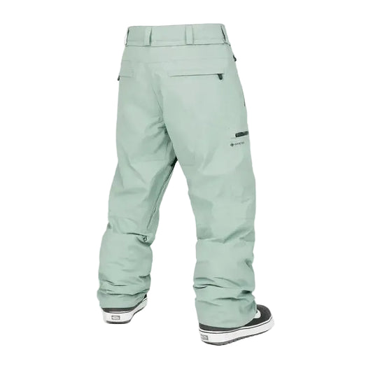 Light green snowboarding pants with zippered pockets and reinforced cuffs, back view
