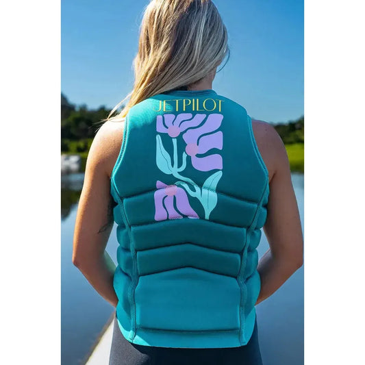 Woman wearing Jetpilot teal ladies life jacket with pink and green floral design by a lake