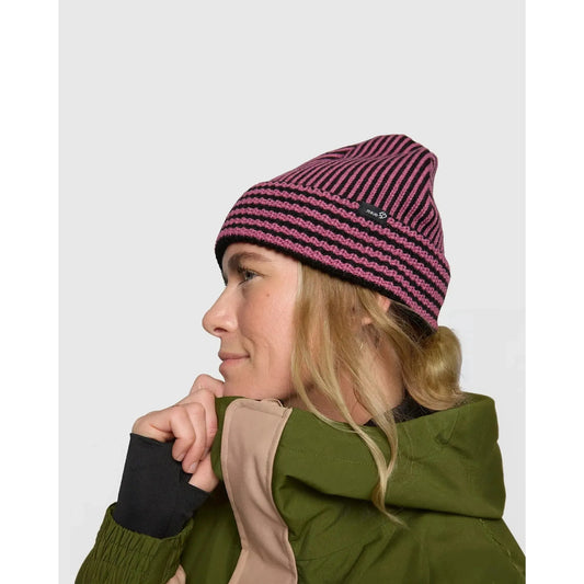 Rojo Vert Beanie Person wearing a striped beanie and green jacket on a plain background
