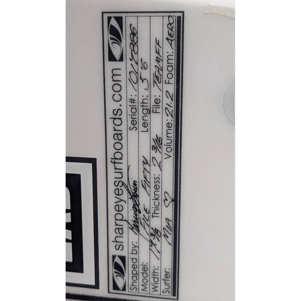 Close-up of a surfboard label with text and branding