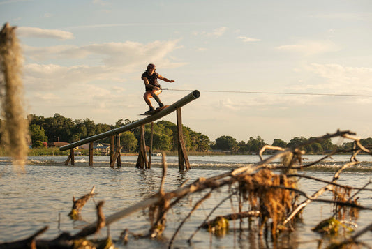 Anna Nikstad, Welcome Board Store co-founder, riding a rail on her wakeboard at sunset