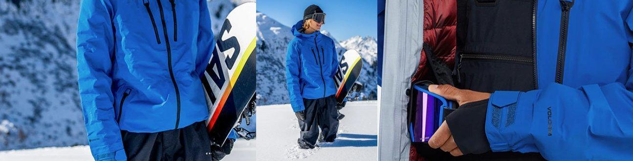 Snowboarder in blue jacket holding snowboard on snowy mountain, Welcome Boardstore gear