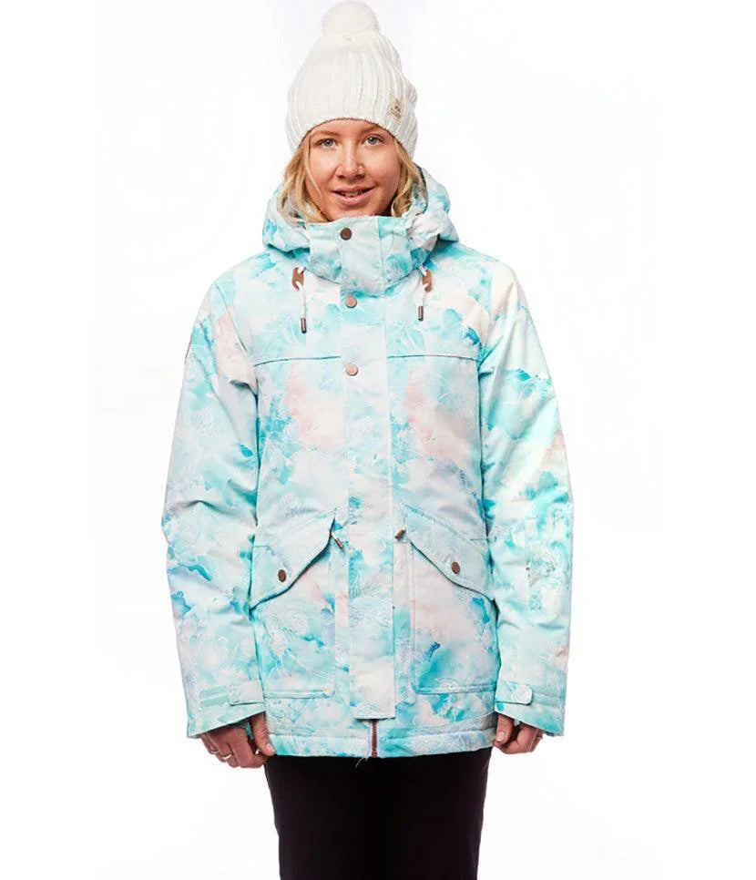 Woman wearing a pastel floral snow jacket and white knit beanie, winter outerwear