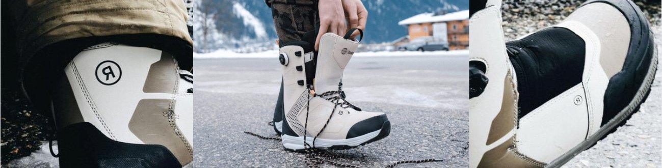 Snowboard boots on pavement with mountain and snow background at Welcome Boardstore