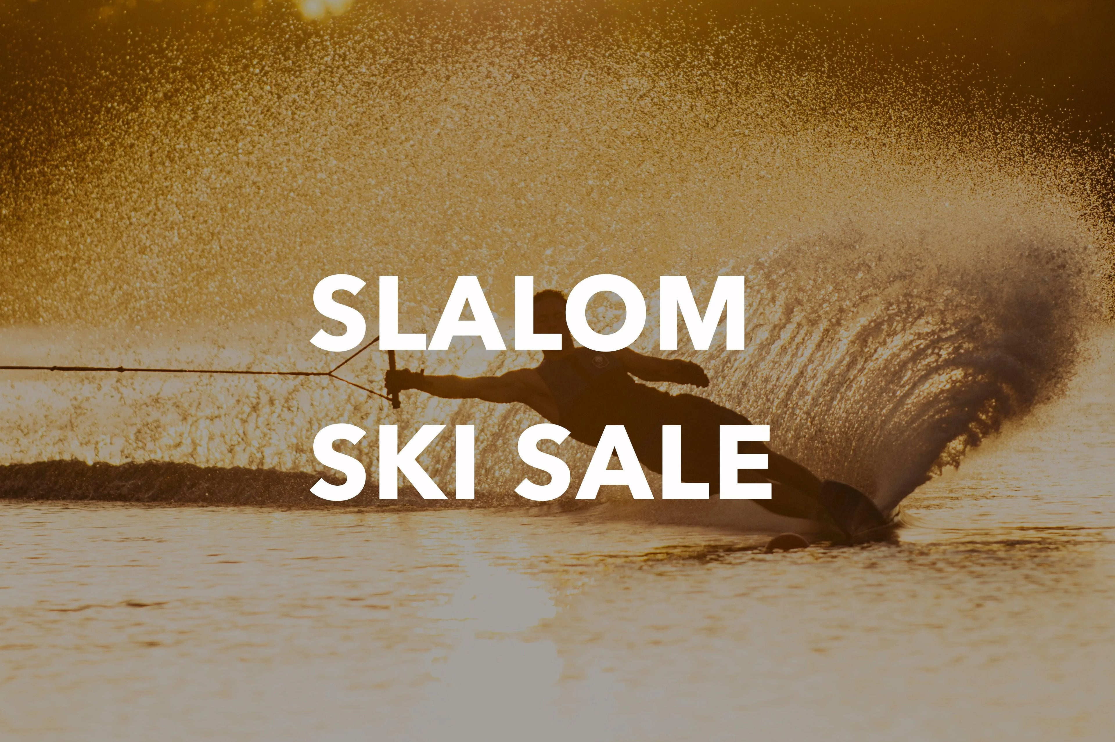 Slalom skier cutting through water at sunset, promoting ski sale at Welcome Boardstore