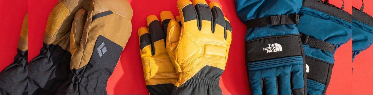 Assorted snowboarding gloves by Black Diamond, The North Face on red background