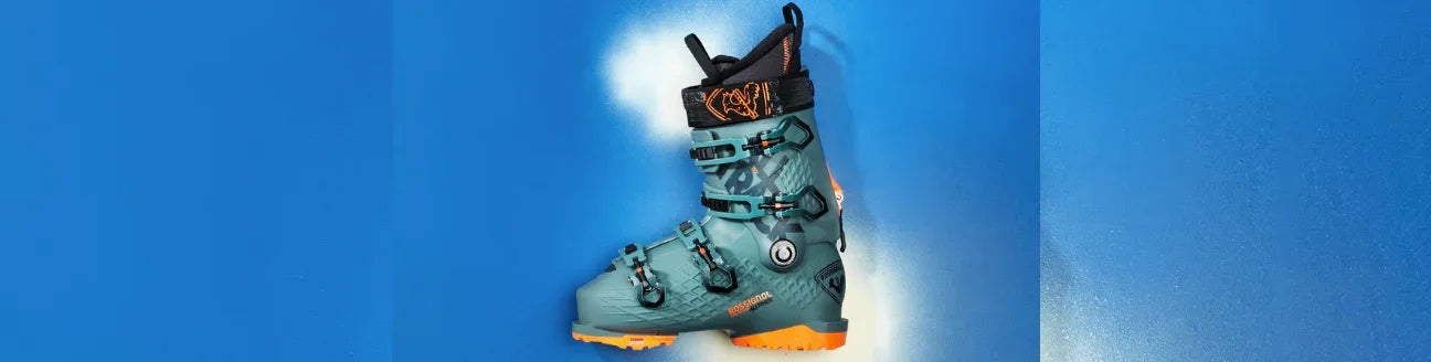 Teal Rossignol snowboard boot with orange sole on vibrant blue background, Boardstore gear