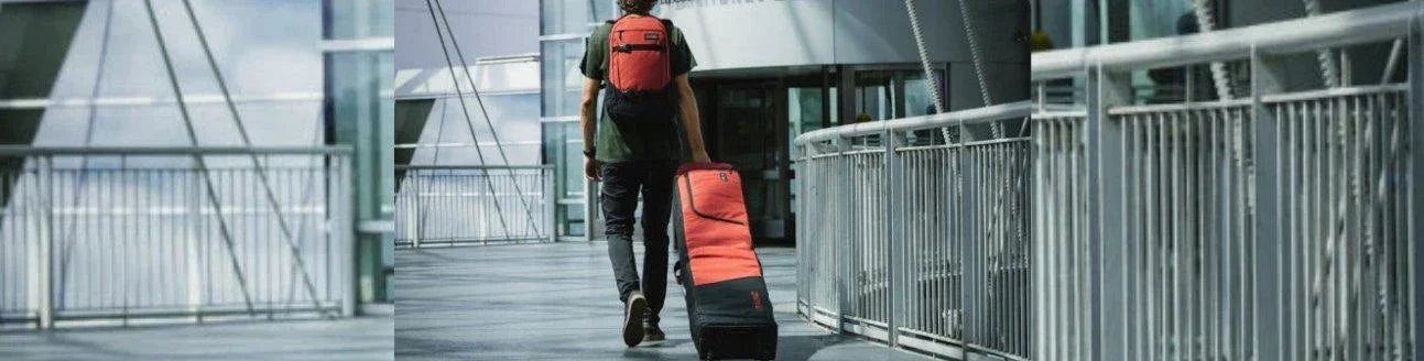 Person walking in modern walkway with orange snowboarding travel bag and backpack from Boardstore