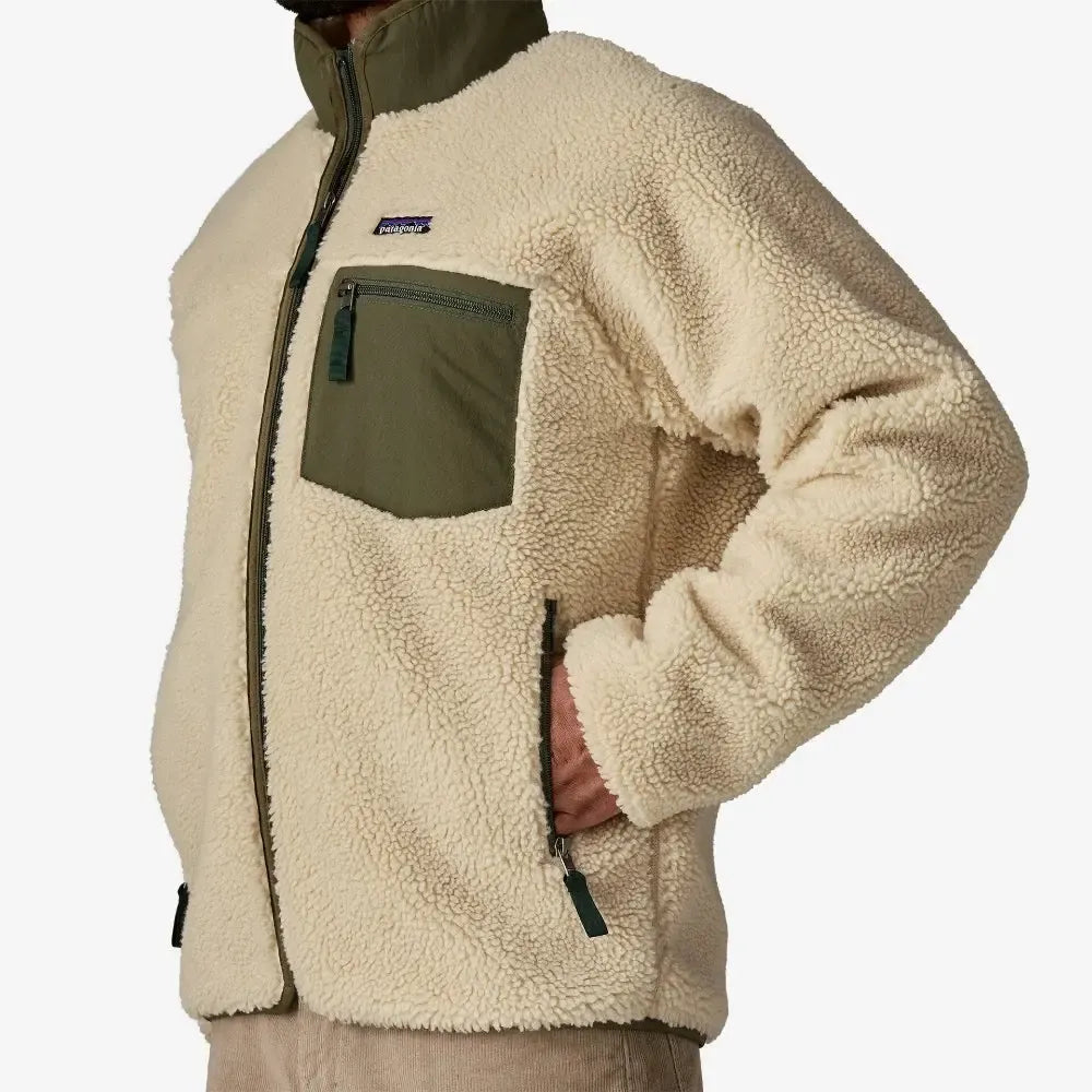 Beige fleece jacket with a green pocket and visible brand logo on a white background welcome boardstore