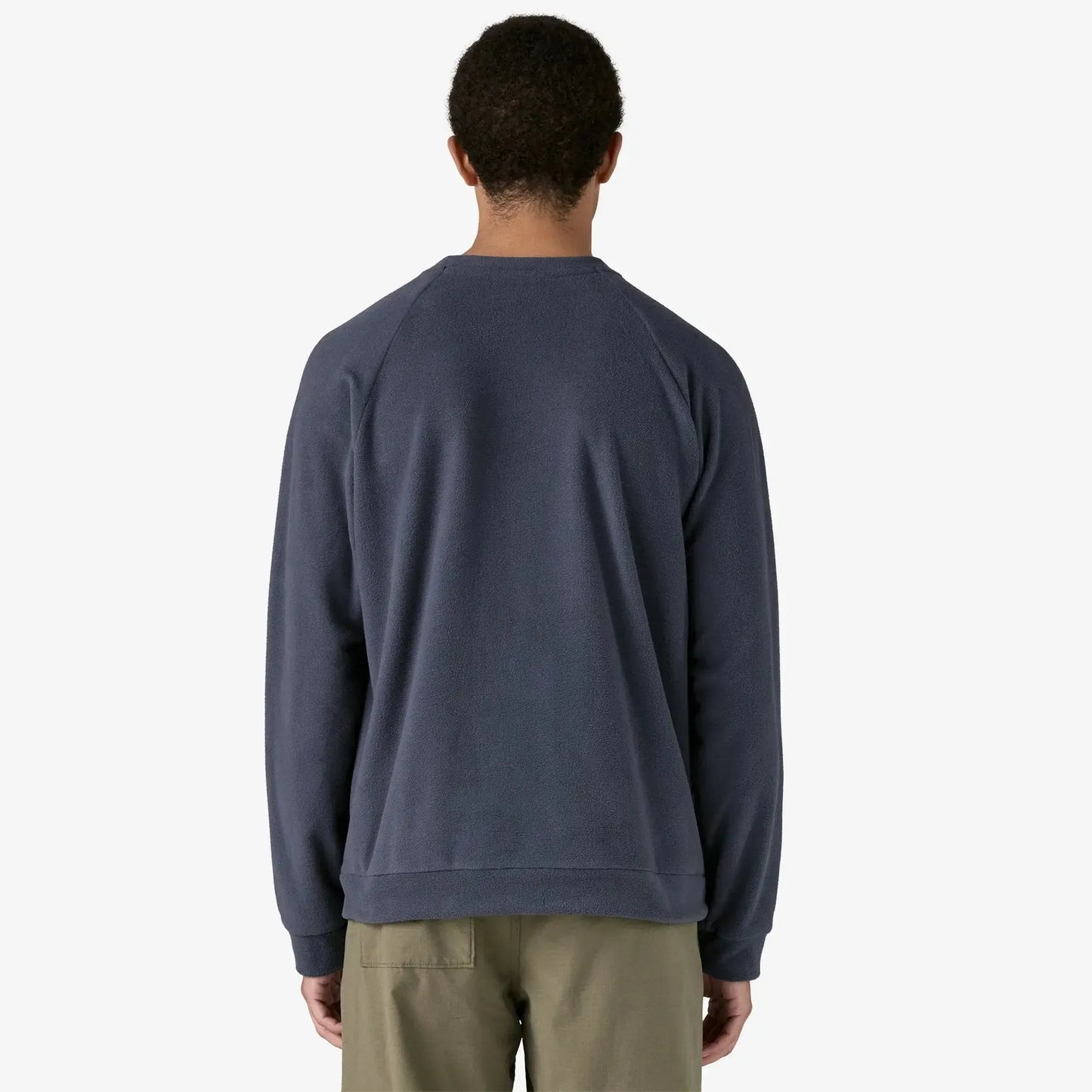 Man wearing a dark blue sweatshirt on a white background Back view
