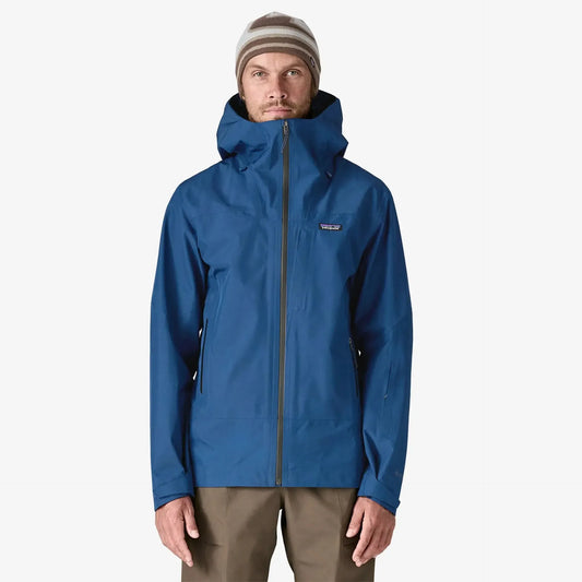 Person wearing Patagonia Men's Storm Shift Jacket a blue jacket on a white background