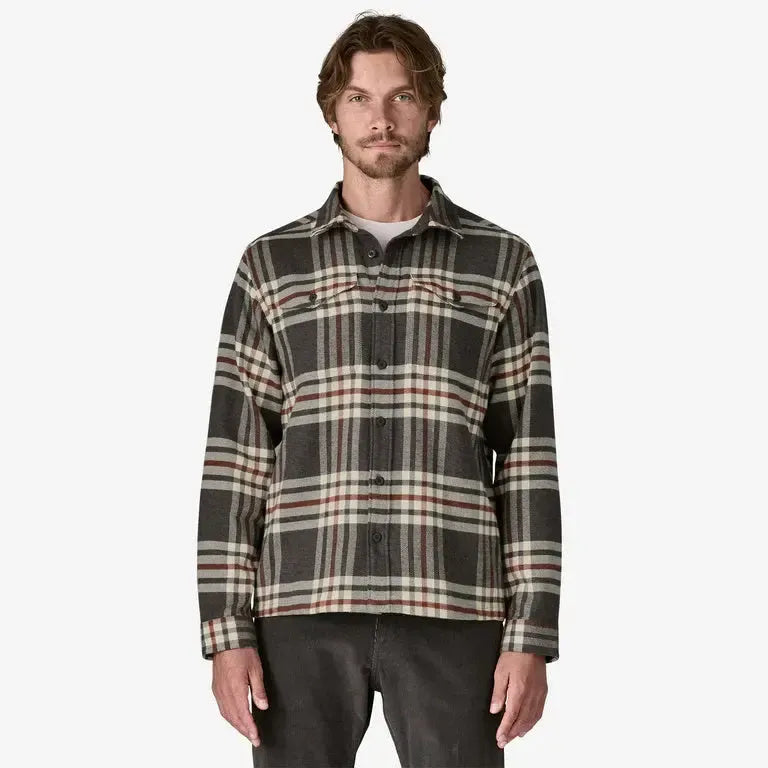 Patagonia Men's Fjord Flannel Shirt | Ink Black | Man wearing a plaid shirt on a white background