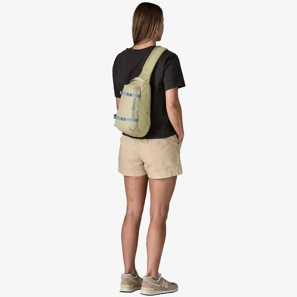 Person wearing a beige backpack on a white background welcome boardstore