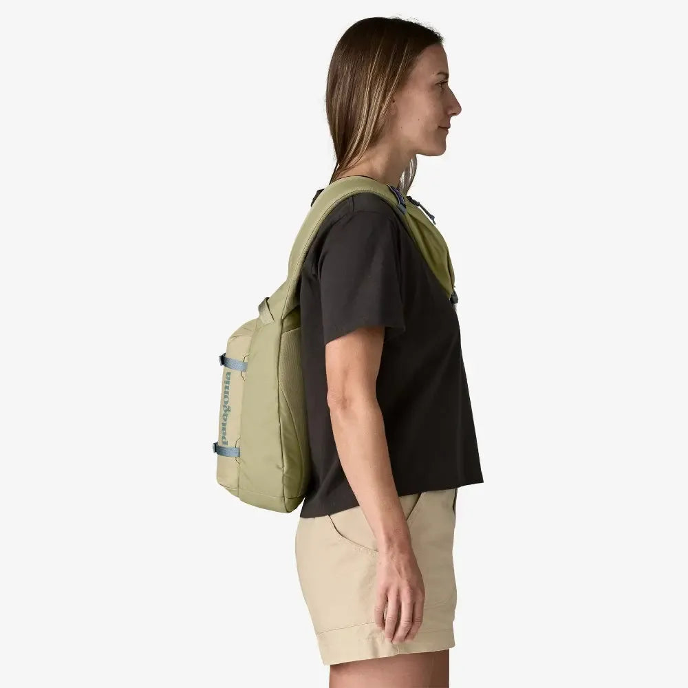 Woman wearing a green backpack on a white background welcome boardstore