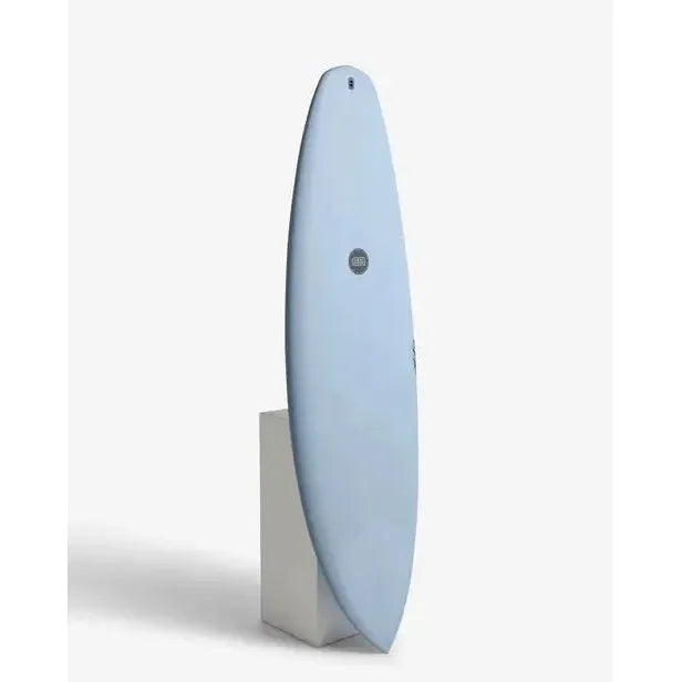 Light blue surfboard upright on white stand, surf essentials at Welcome Boardstore