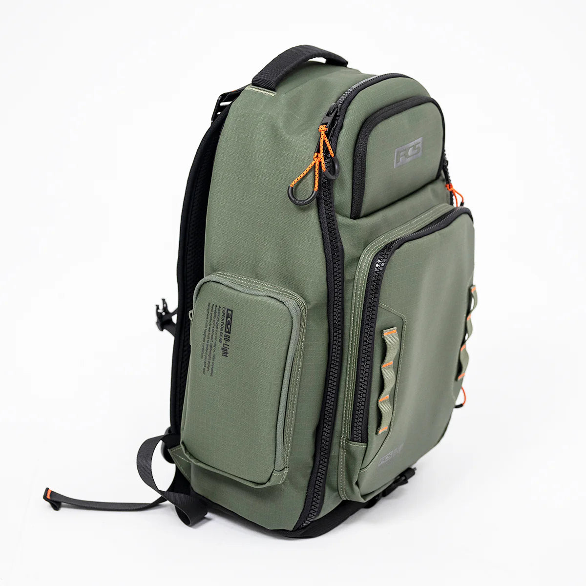 Green FCS Day X Pack 24L backpack with multiple pockets and straps on a white background