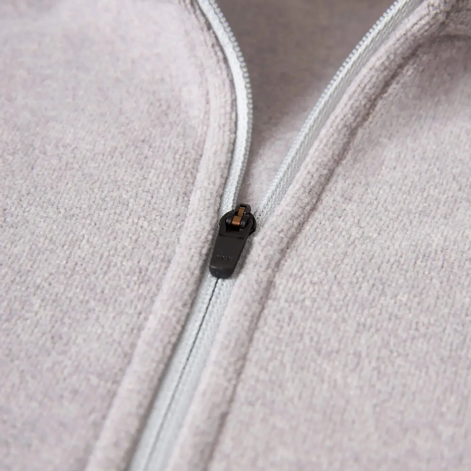 Florence Marine X Polartec Fleece Half Zip Close-up of a zipper on a light gray fleece jacket