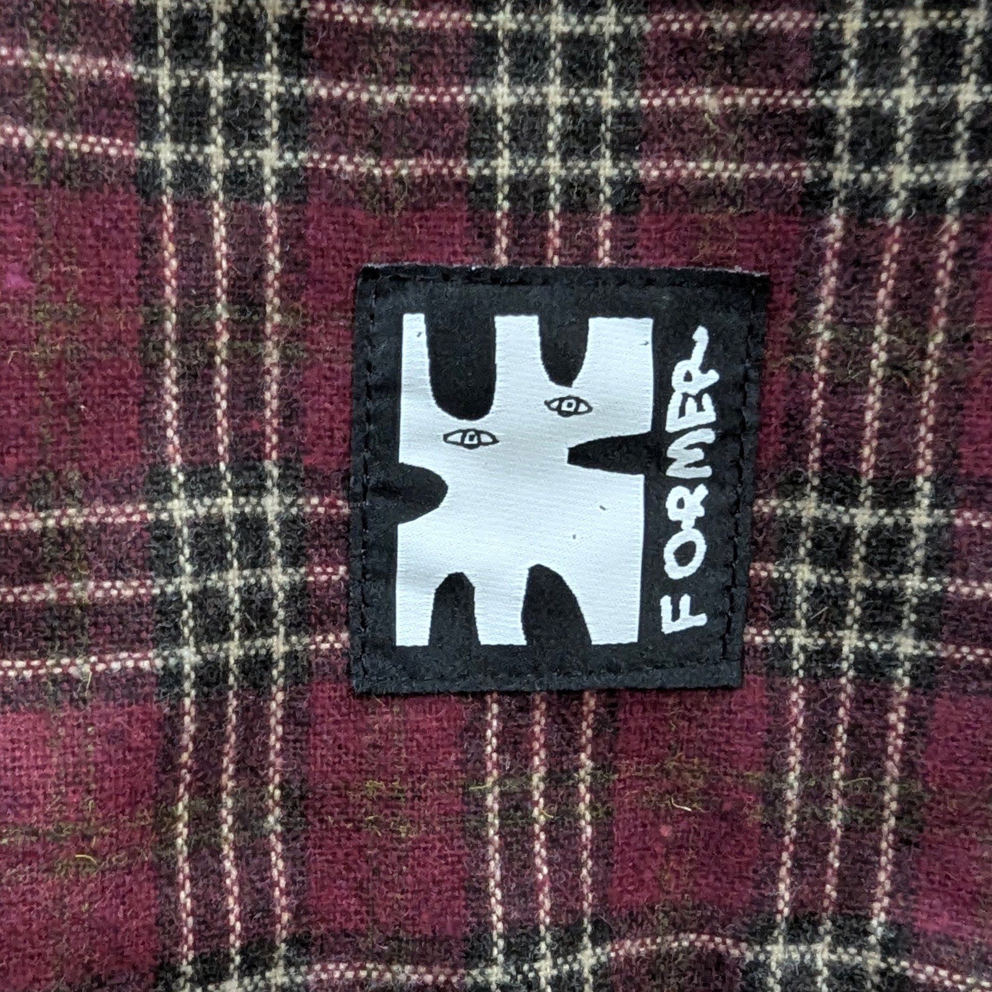 Plaid fabric with a 'Former' brand patch in the center welcome boardstore