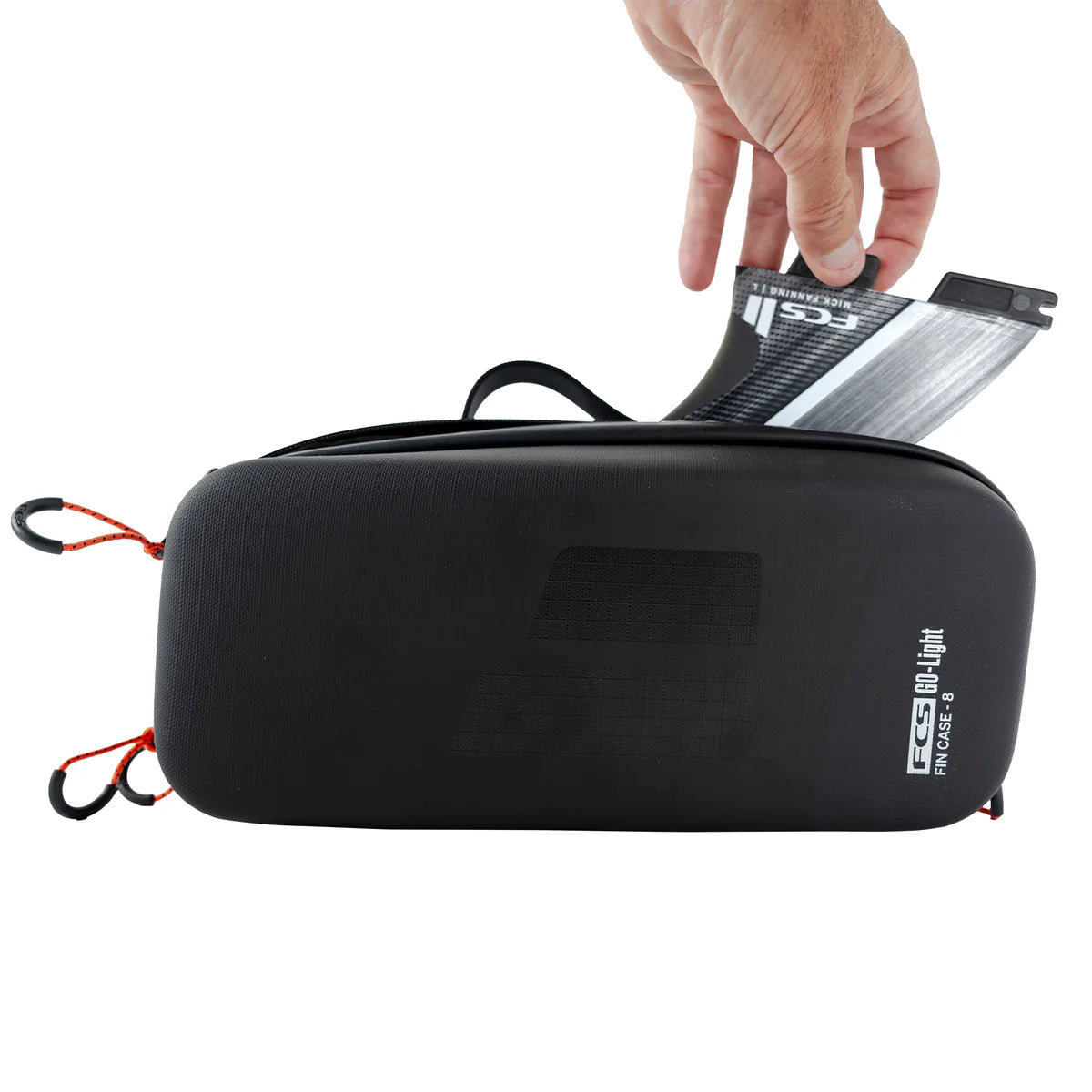 FCS Go Light Fin Case Black carrying case with a hand placing a small device inside on a white background