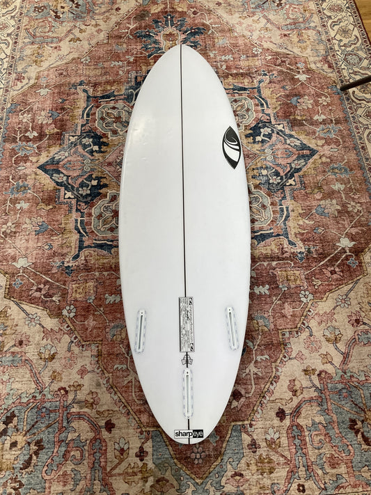 Bottom of white Sharpeye Inferno 72 pre-loved surfboard with Futures thruster fin boxes