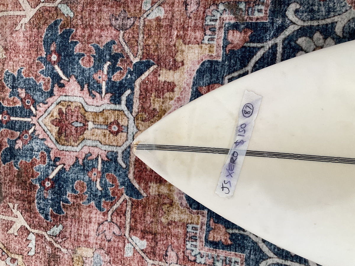 Nose of the white JS Xero pre-loved surfboard with price tag