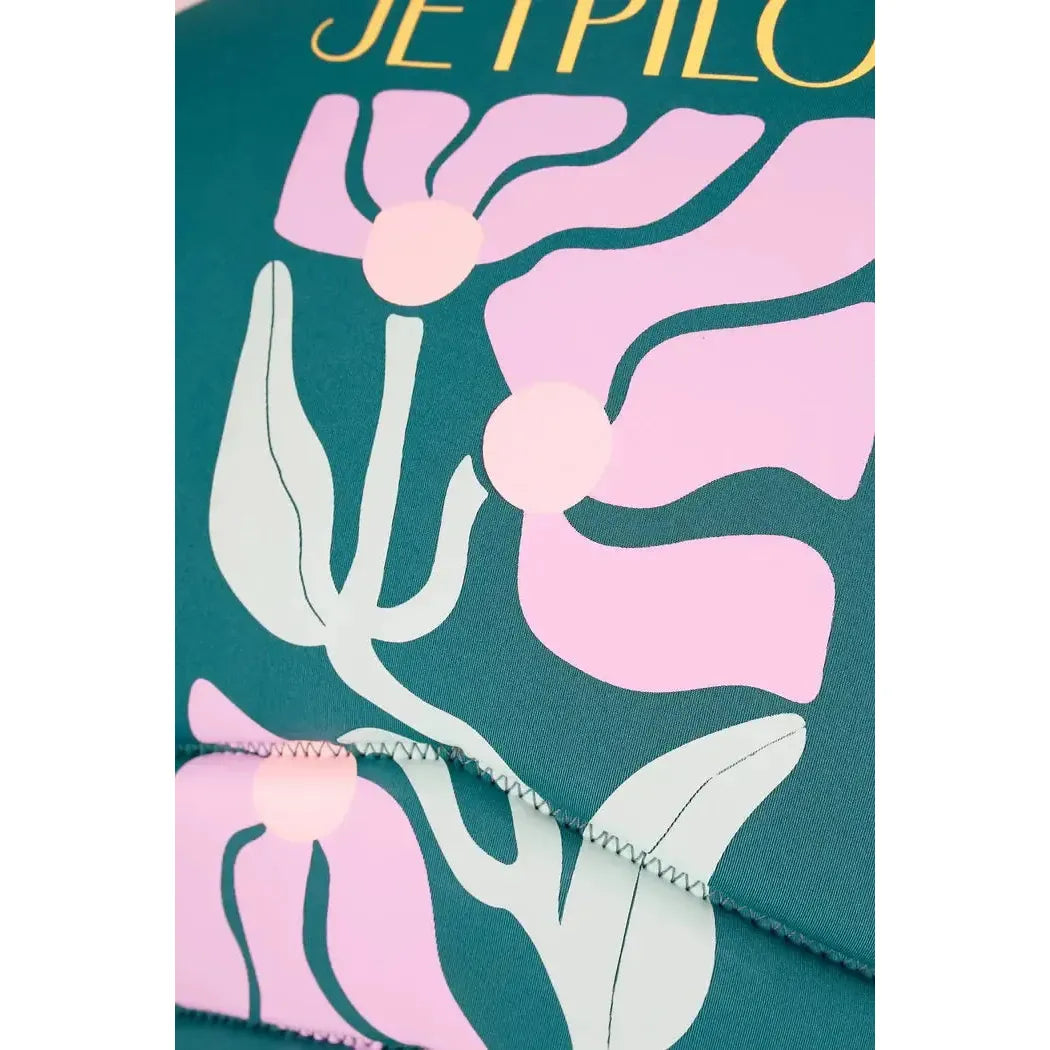 Jetpilot eco vest with pink floral print on green fabric, wakeboard vest closeup