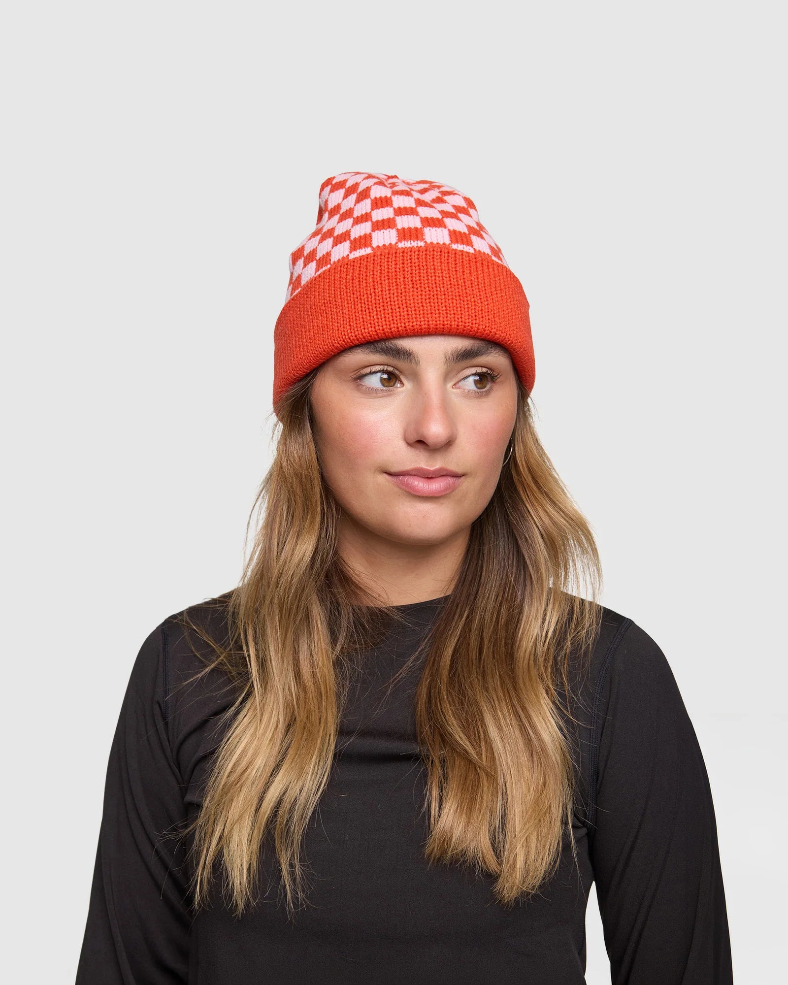 Rojo Cosy Check Beanie Person wearing a red and white checkered beanie on a plain background
