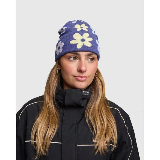 Rojo Spring Bloom Beanie Person wearing a purple beanie with floral patterns and a black jacket on a light gray background
