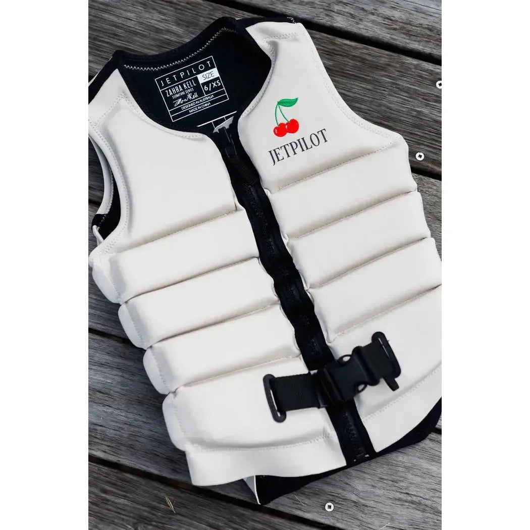 Jetpilot Zahra Off White wakeboard vest with cherry logo on wooden deck