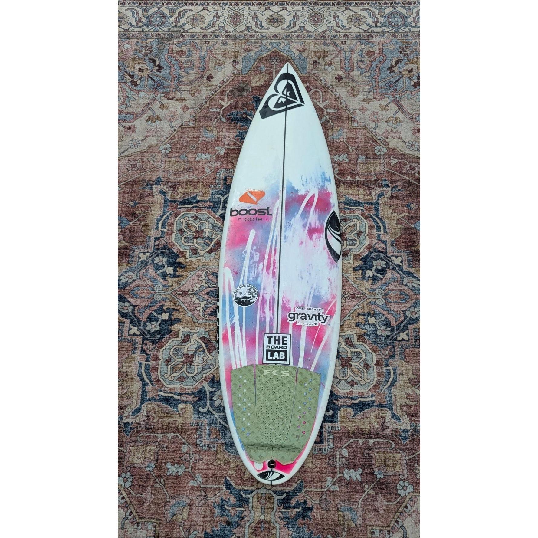 Surfboard with visible branding on a patterned rug sharpeye WBS