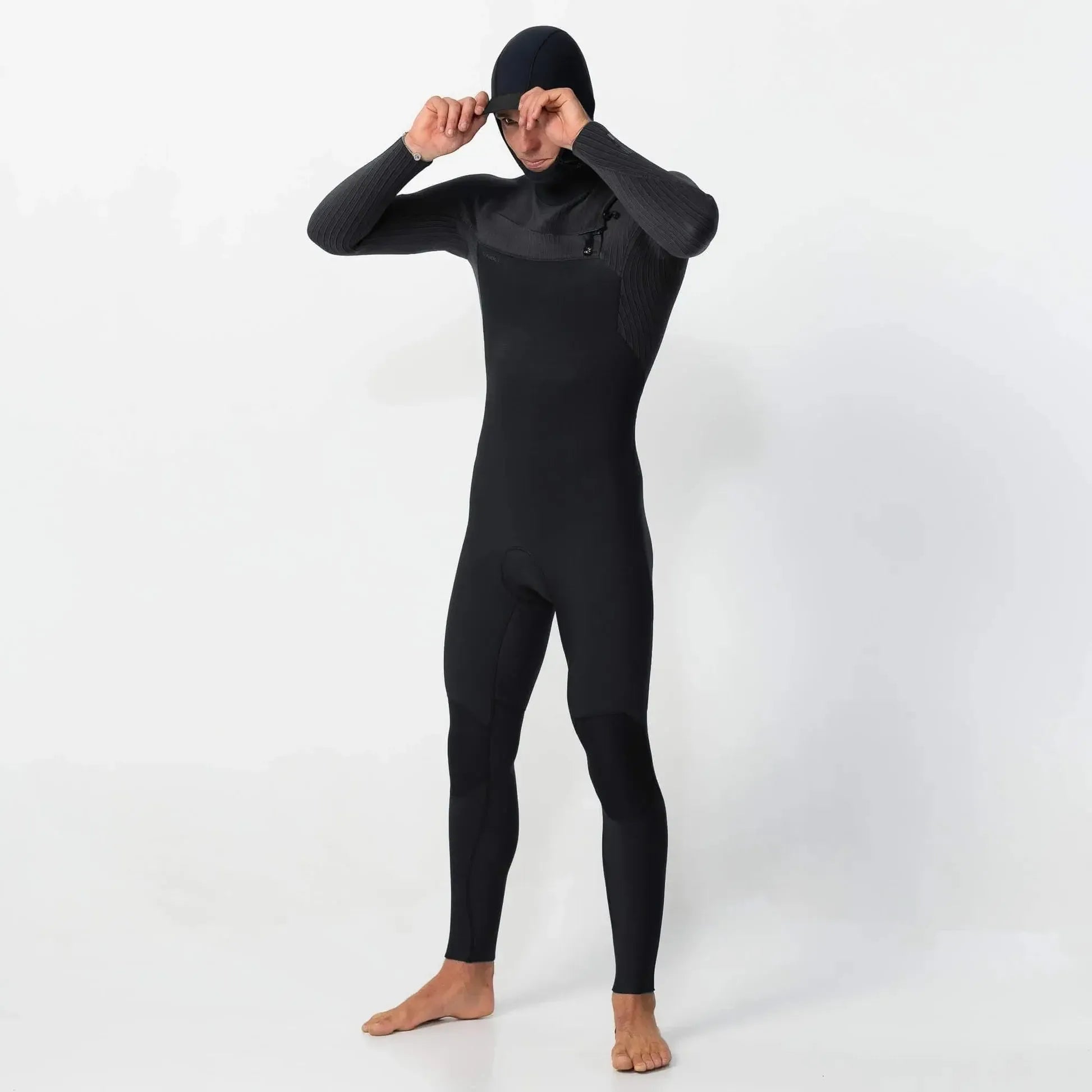 Person wearing a black wetsuit on a white background