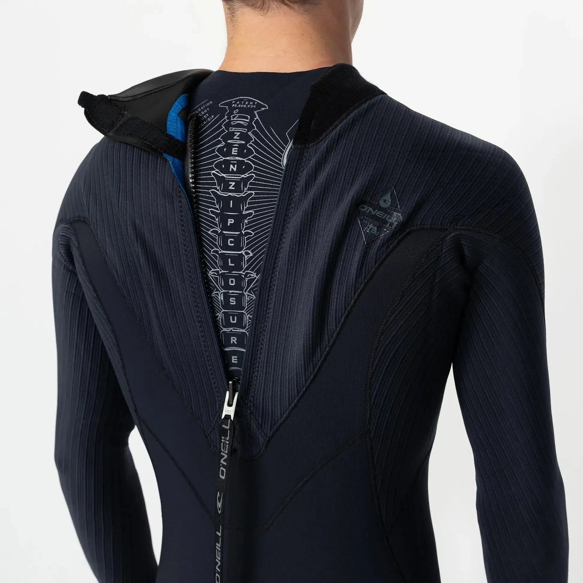 Close-up of a black wetsuit with text on the back against a white background