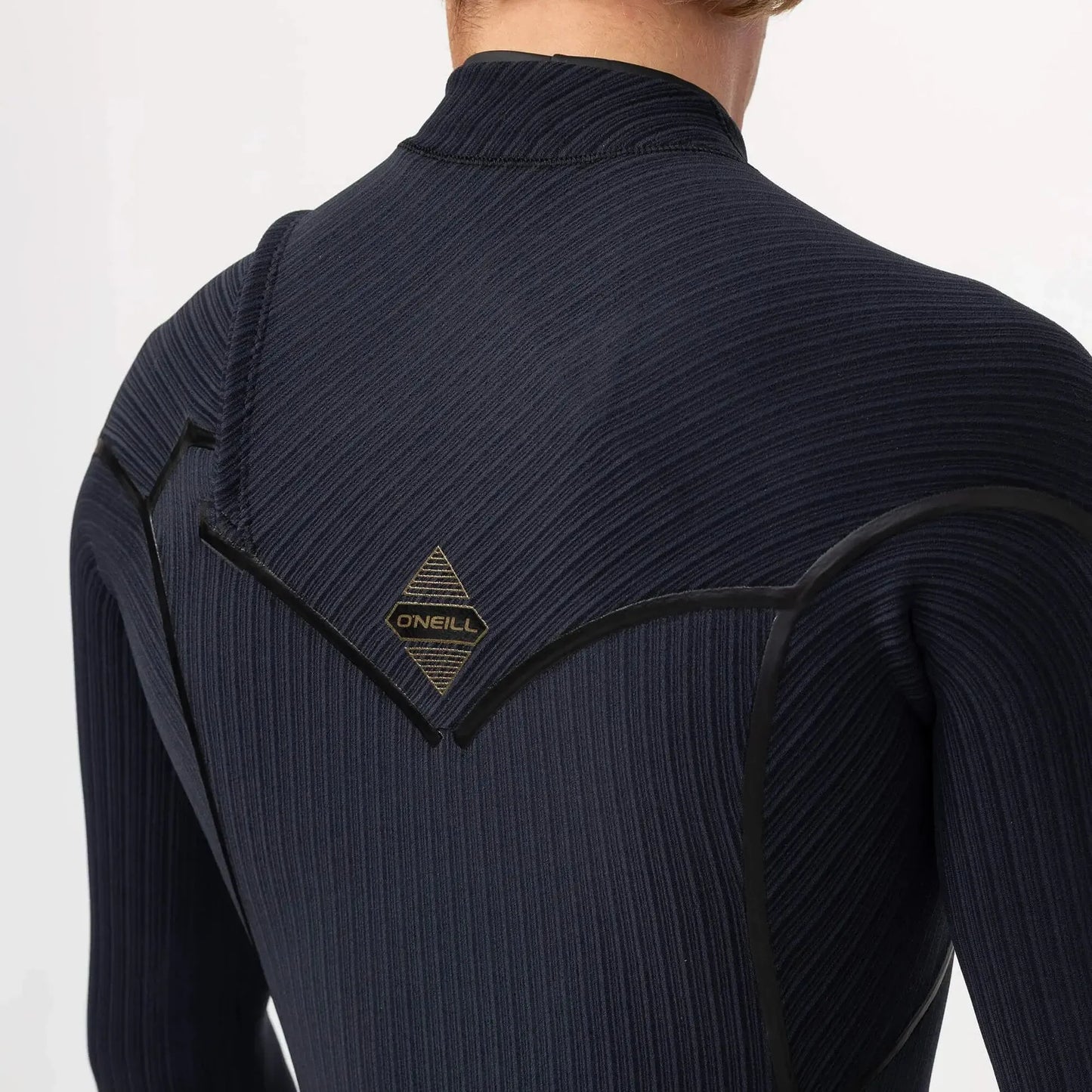 Back view of black men's chest zip wetsuit with textured panels and gold triangle logo